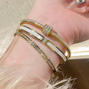 Pulseira de aço titânico e ouro